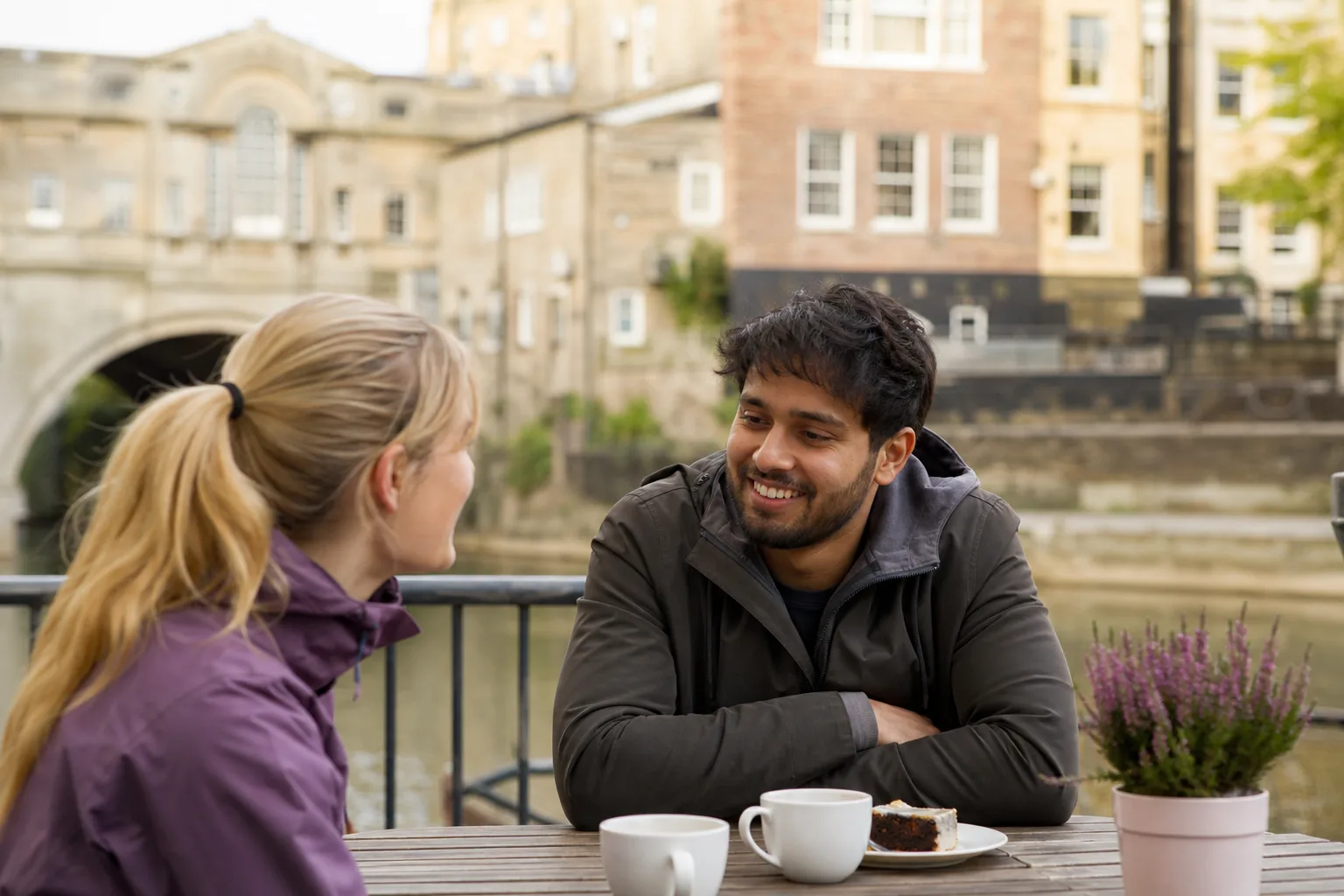 Two people walking beside the River Ouse in York